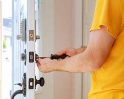 Worker installing or repairing new lock handyman repair the door lock